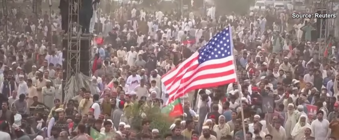 A PTI workers waives US flag at the party's rally in Swabi, on November 9, 2024.